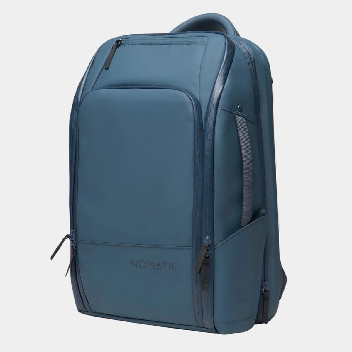 Nomatic Travel Pack 20L in slate blue, shown at a three-quarter angle with its front organiser pocket, side carry handle and expansion zip