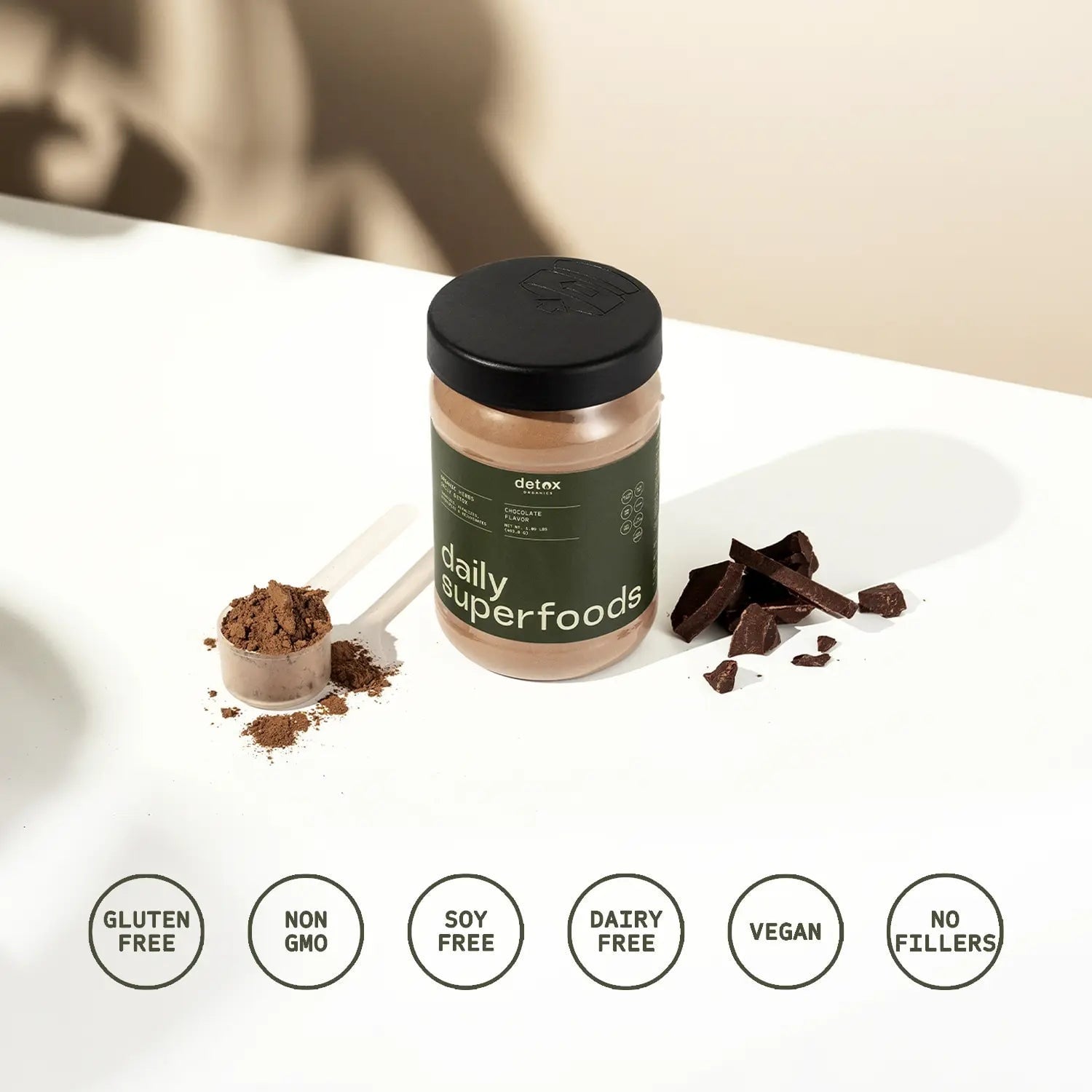 Detox Organics Daily Superfoods tub with scoop of chocolate powder and free-from badges