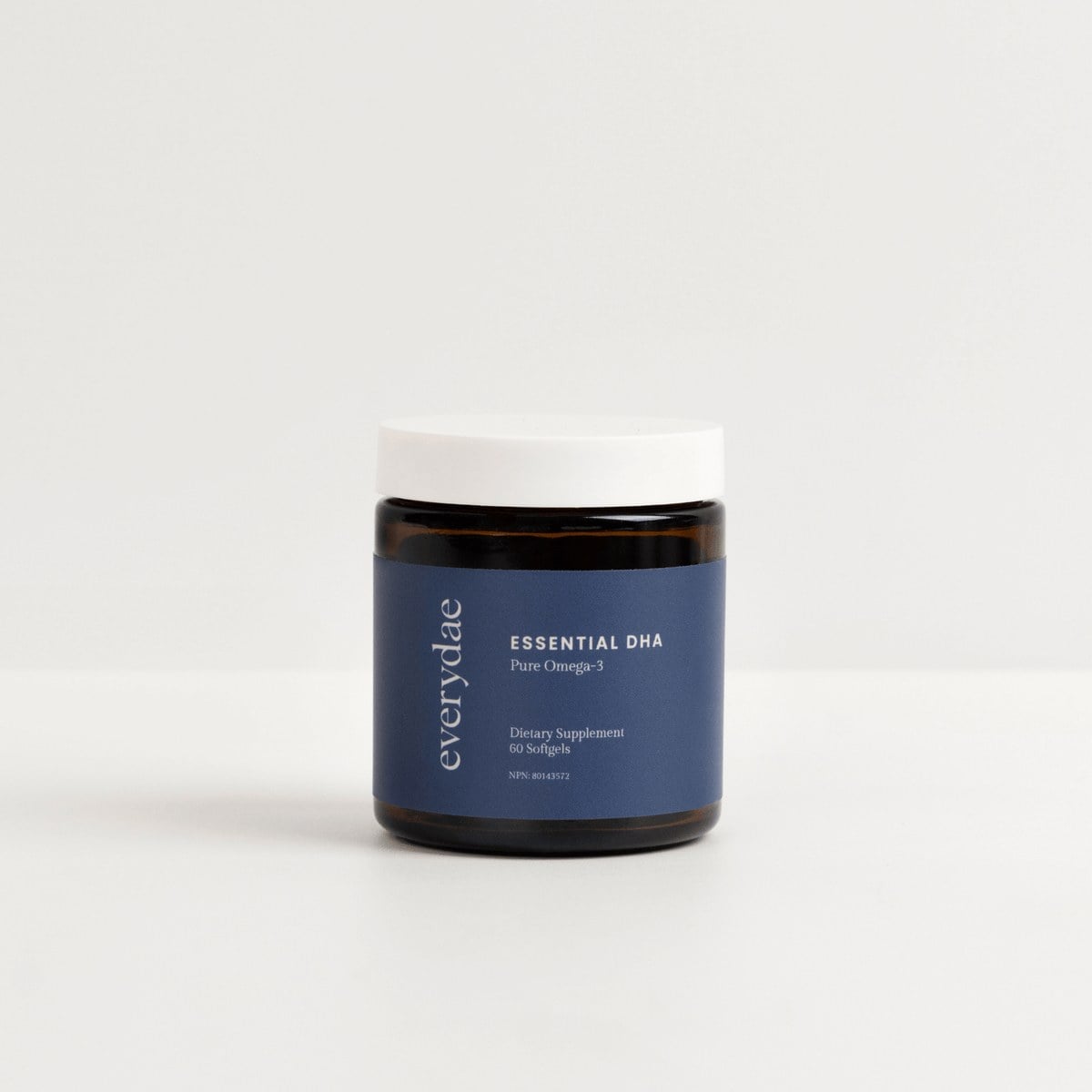 Navy Everydae Essential DHA omega-3 jar with white lid on a light background