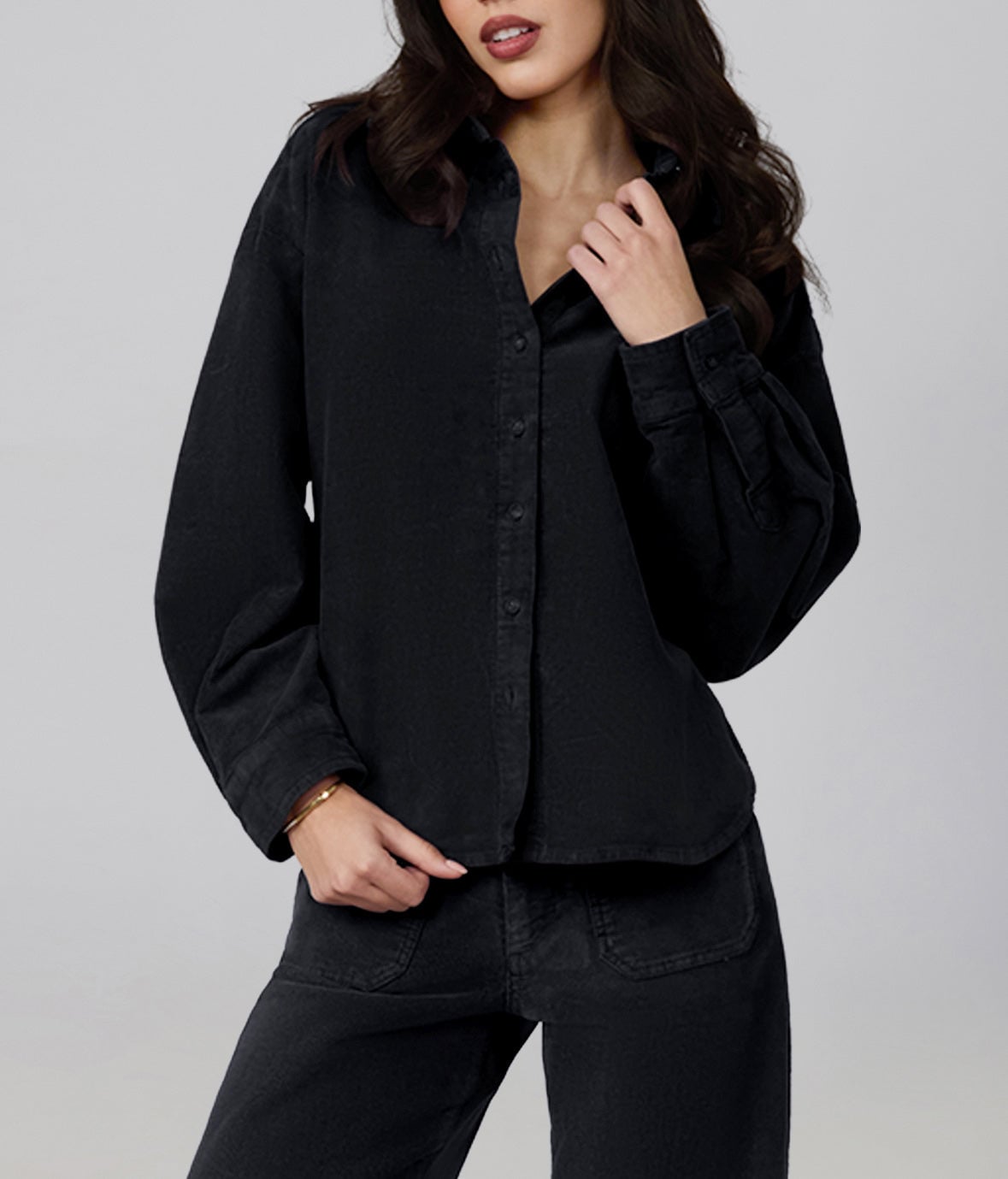 Model wearing the Lola Denim MARGOT oversized black corduroy shirt buttoned over matching black corduroy wide-leg trousers
