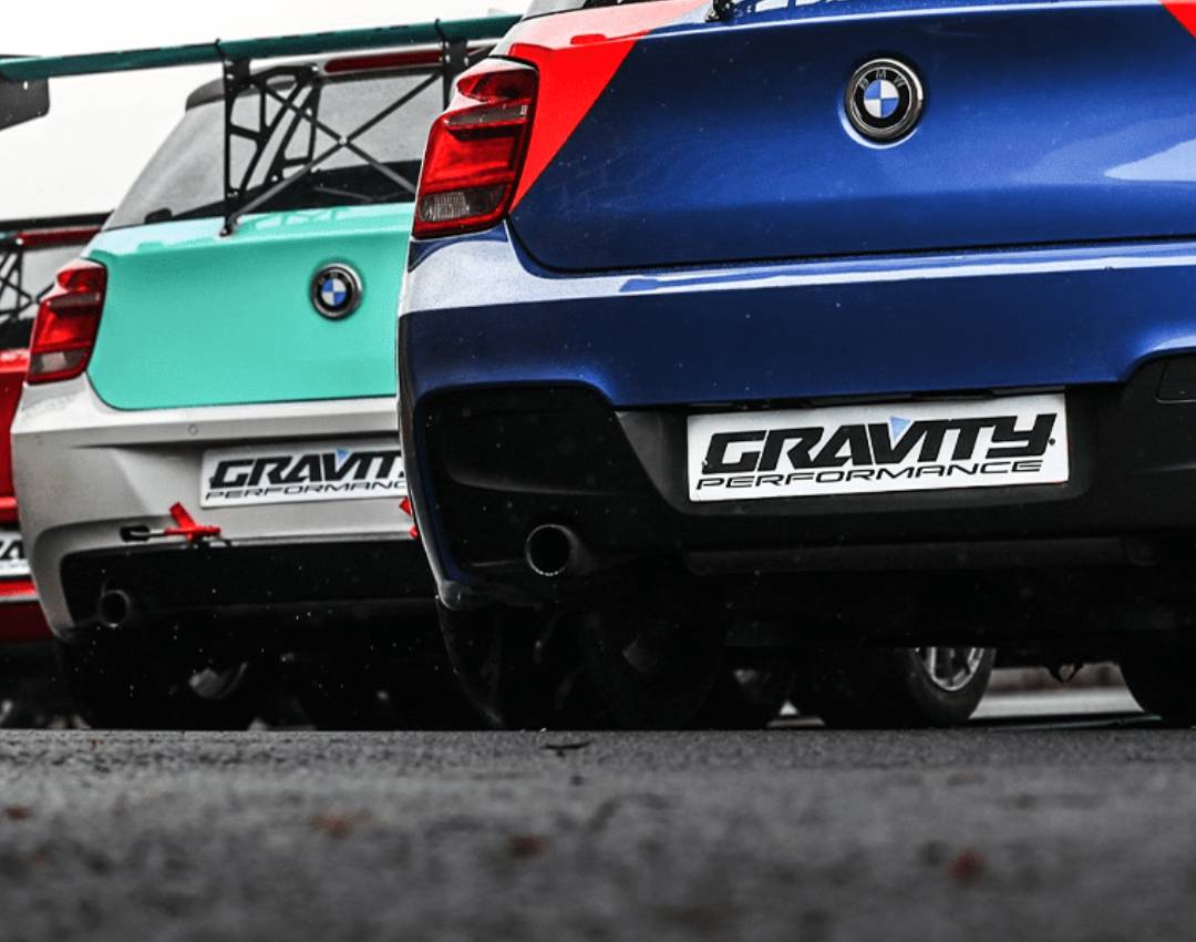 Row of compact cars in various colors with performance branding displayed